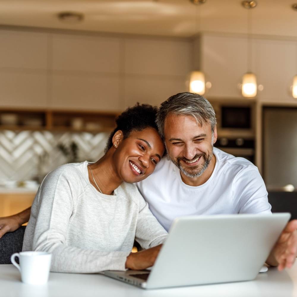 Couple in Kitchen on Laptop